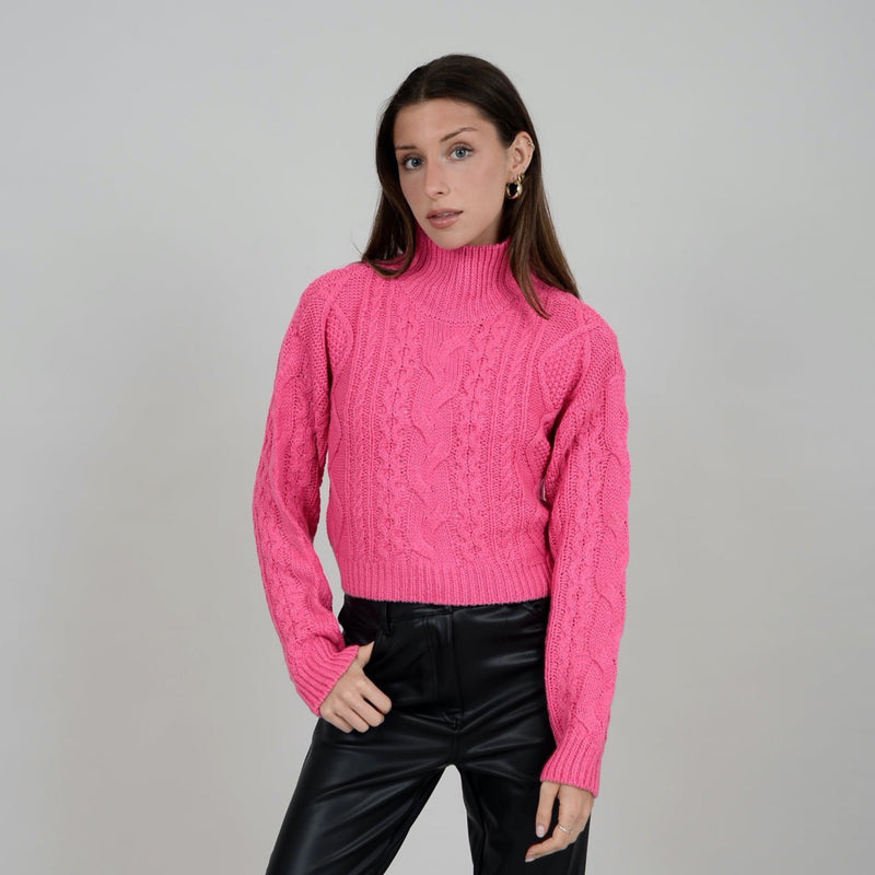 Front view of model wearing Erin crop. Shows that sweater is cropped. Also shows the turtleneck and the cable knit detail. 