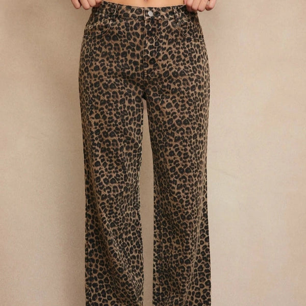 front view of the model wearing the wildfire leopard boyfriend jeans. shows the mid- rise, the leopard print and the boyfriend fit. 