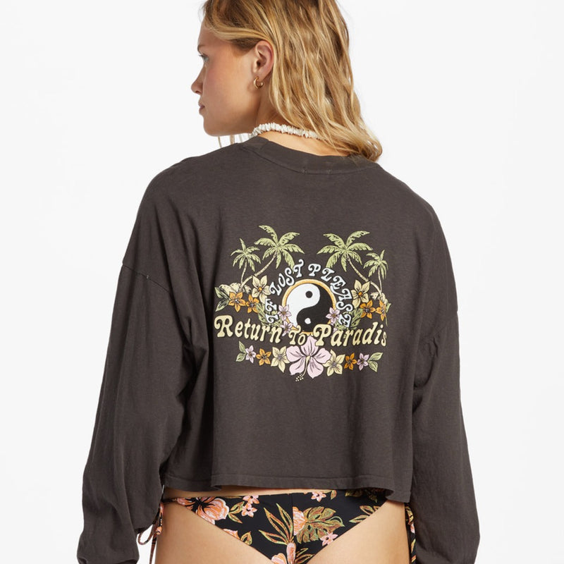 back view of the model wearing the beach boyfriend crop top in black sands. shows the back graphic on the top. also shows the back being a little longer than the front, the crew neckline and the ribbed detail on the neckline. 