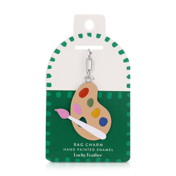 Bag charm with paint palette design on a green and white packaging