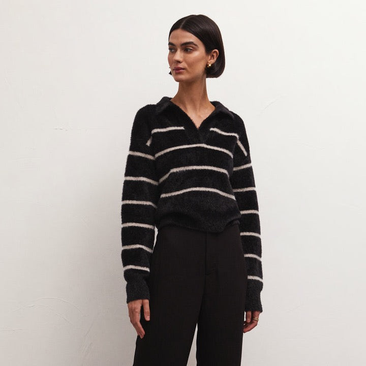 front view of the Monique sweater striped in black. shows the v neck collared neckline. also shows the relaxed fit, the drop shoulders, and the warm and fuzzy yarns.