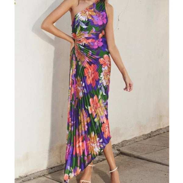 front view of the model wearing the make an entrance dress. shows the asymmetrical neckline. also shows the pleats throughout and the side keyhole.  