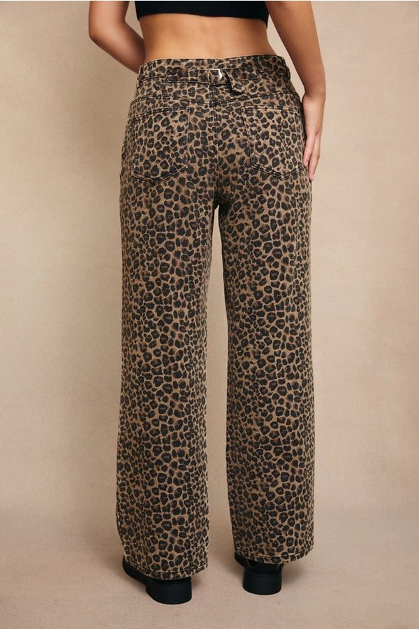 back view of the model wearing the wildfire leopard boyfriend jeans. shows the back buckle. also shows the leopard print, the back pockets, the mid rise and the boyfriend fit. 