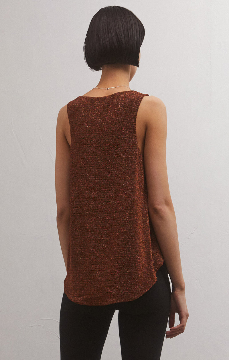 back view of model wearing vagabond tank in chocolate. shows the high neck on the back. also shows the shirttail hem on the back, the sparkle detail and that that the top is sleeveless. 