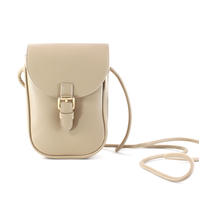 front view of cassidy buckle crossbody in apricot. shows the gold buckle front detail, the front flap and crossbody strap.  