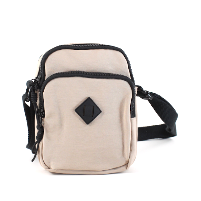 front view of the jamie nylon crossbody in tan. shows the diamomd detail on the front, the three different zipper closure compartments and the black adjustable strap. 