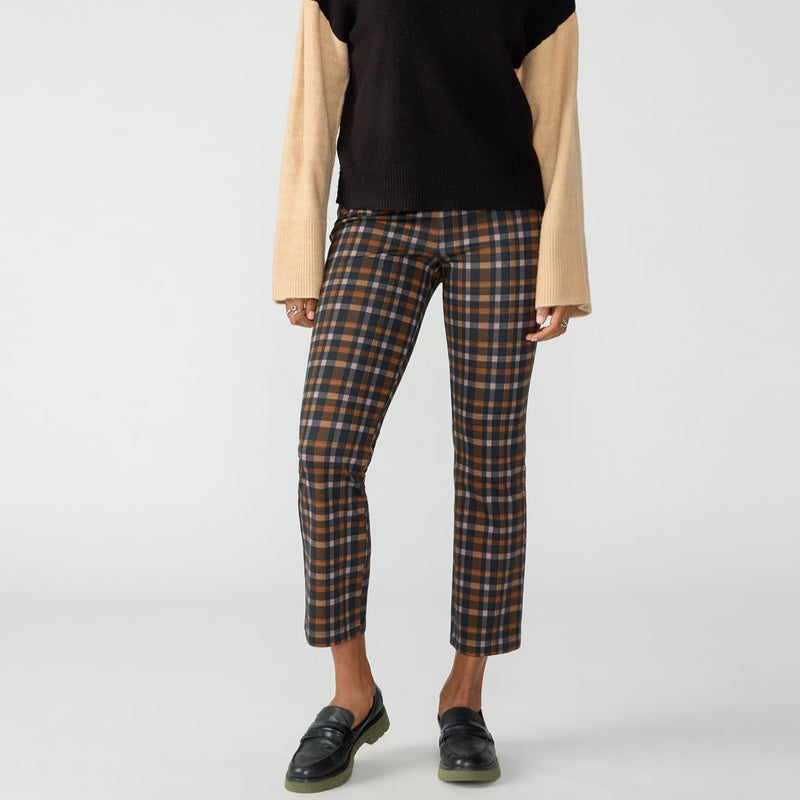front view of model in plaid leggings. shows a fitted leg with a kick flare cropped leg. 
