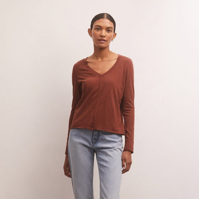  shows front view of model in rosewood color. shows the v-neckline, long sleeves, and seam down the center.