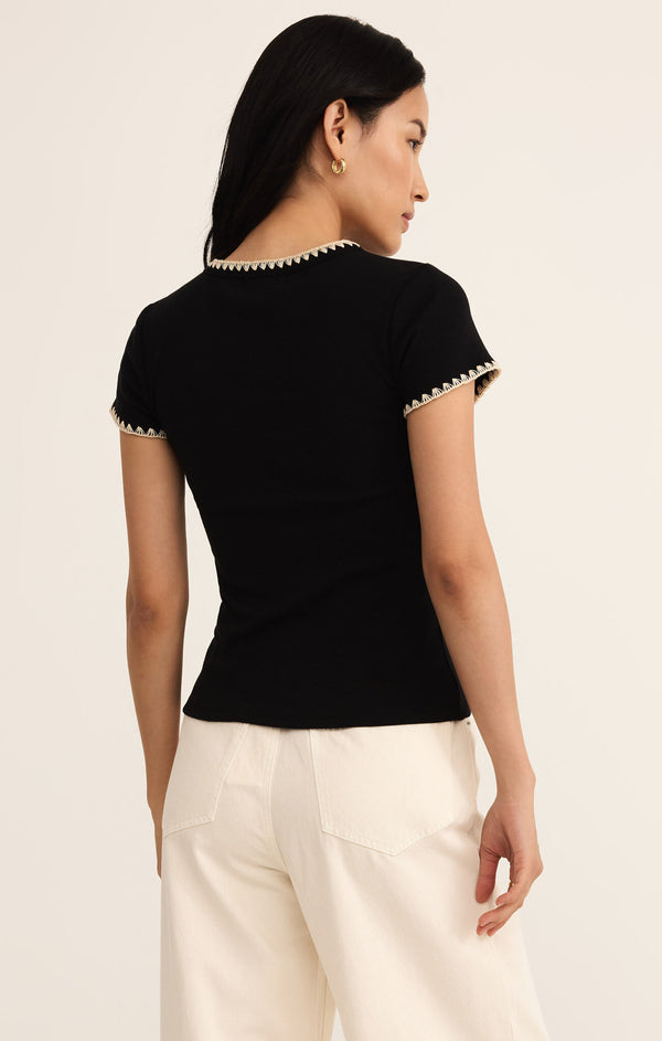 back view of the model wearing the cassis rib tee. shows the fitted style. also shows the ribbed detailing, the cream stitching and the short sleeves. 