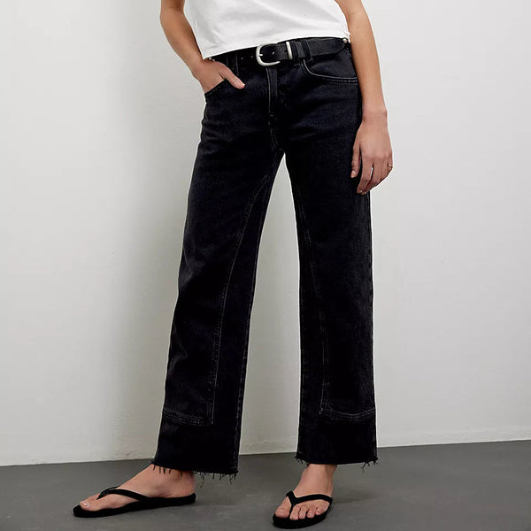 front view of the risk taker jeans. shows the black color. also shows the mid rise, the raw hem line, the utility seaming throughout. 