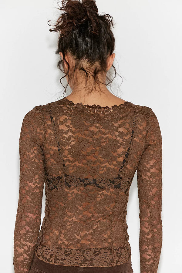 Brown lace long-sleeve top worn by a person on a white background