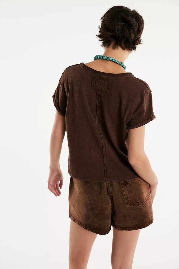 Person wearing a brown t-shirt and shorts set on a white background
