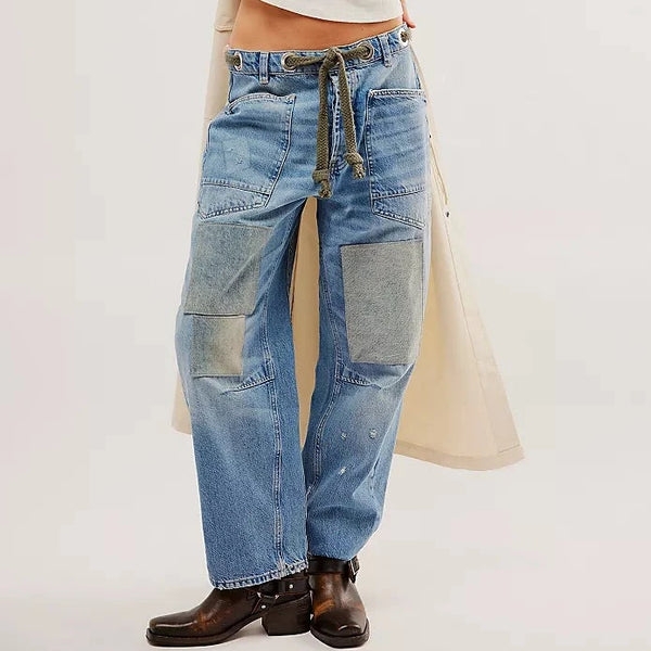 front view of the model wearing the moxie low slung pull on barrel. shows the low waist. also shows the pull-on style, the tie waist, the oversized patch work and the paint splatter features. 