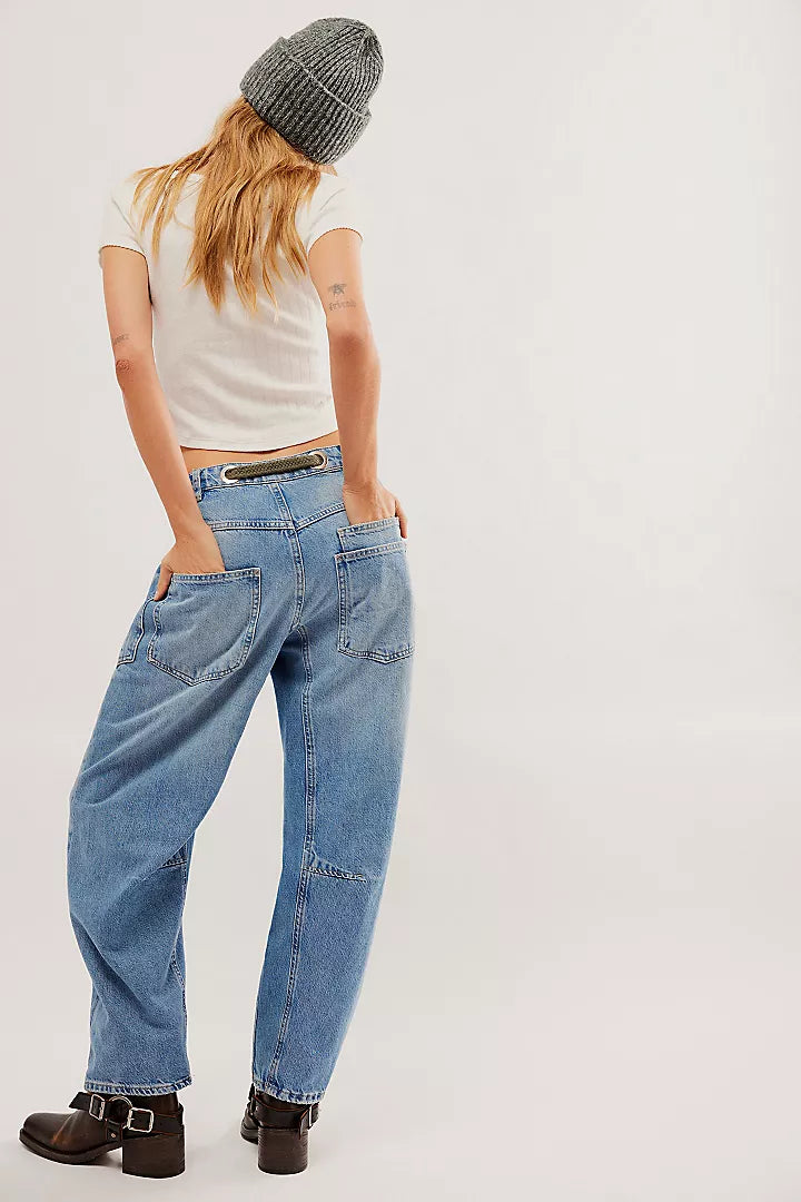 back view of the model wearing the moxie low slung pull on barrel. shows the back patch pockets. also shows the defined seaming throughout and the tie waist detail. 