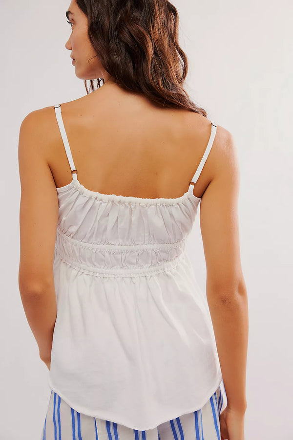back view of the model wearing the scarlett tank. shows the top ruching detailing. also shows the adjustable straps and back scoop neckline. 