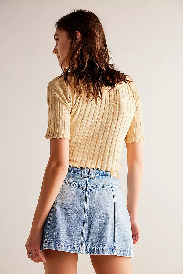 back view of the model wearing the midnight sun skort. shows the defined seaming throughout.  also shows the mid rise, and the belt loops. 