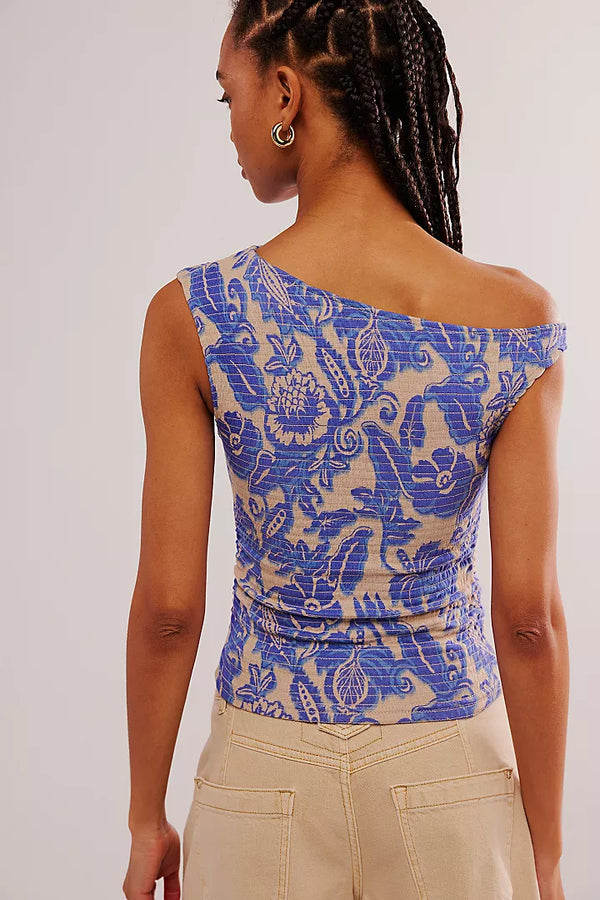 back view of the model wearing the shea top. shows the off the shoulder neckline. also shows the all over smocking, and the slim fit of the top. 