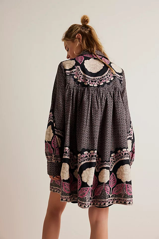 back view of model in dress. here you can see the mini length, a dropped back seam and the loose fit.