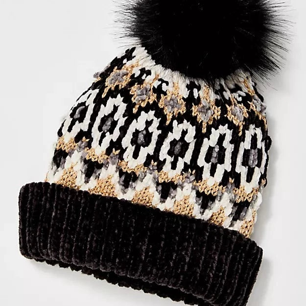 Front view of pom beanie. Shows the Chunky knit fabric. Also shows the fair isle print all over, the faux fur pom detail, ribbed trim, wide cuff and the slouchy design. 