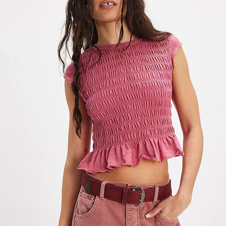 front view of the model wearing the Sylvie tee. shows the bottom ruffle. also shows the ruched front, the crew neckline and the cap sleeves. 