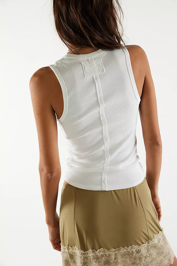 back view of the model wearing the neria tank. shows the raised seam down the middle. also shows the slim fit and the ivory color. 