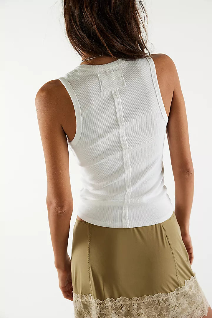 back view of the model wearing the neria tank. shows the raised seam down the middle. also shows the slim fit and the ivory color. 