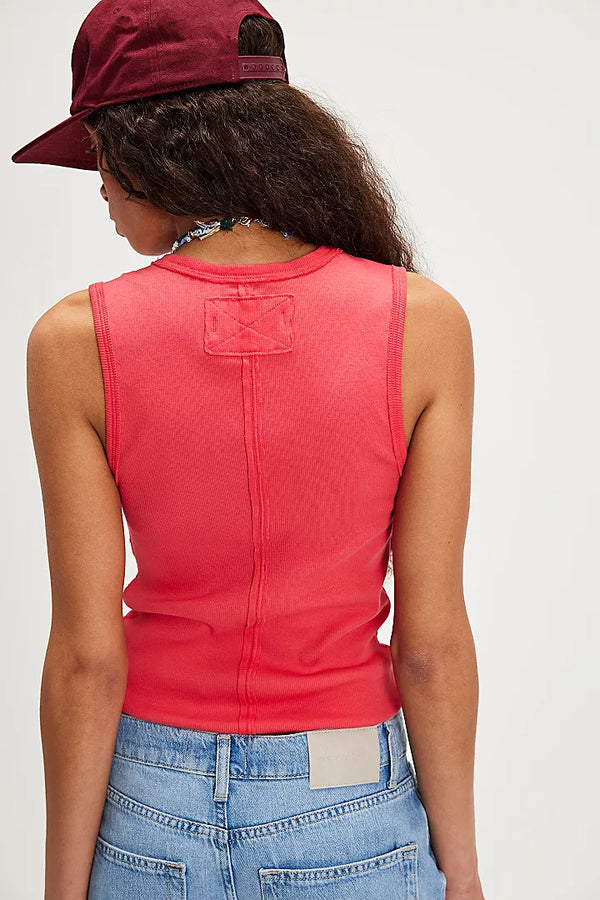 back view of the model wearing the neria tank. shows the raised seaming. also shows the slim fit, the thicker straps and the bright cherry color. 