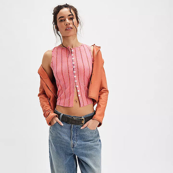 front view of the model wearing the tilly printed vest. shows the stripe pattern. also shows the boat neckline, the button down closure and the slim fit. 