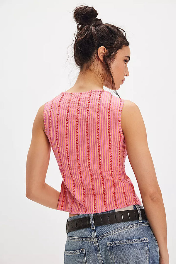 back view of the model wearing the tilly printed best. shows the slim fit. also shows the strip pattern and that it is sleeveless. 