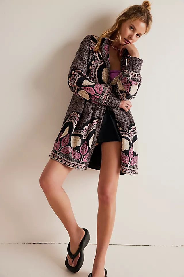 another front view of model wearing the dress open. here you can see the long sleeves rolled down, the mini length and loose fit.