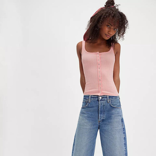 front view of the model wearing the end game pointelle tank. shows the pink color. also shows the button down style, the square neckline, the picot trim and the slim fit. 
