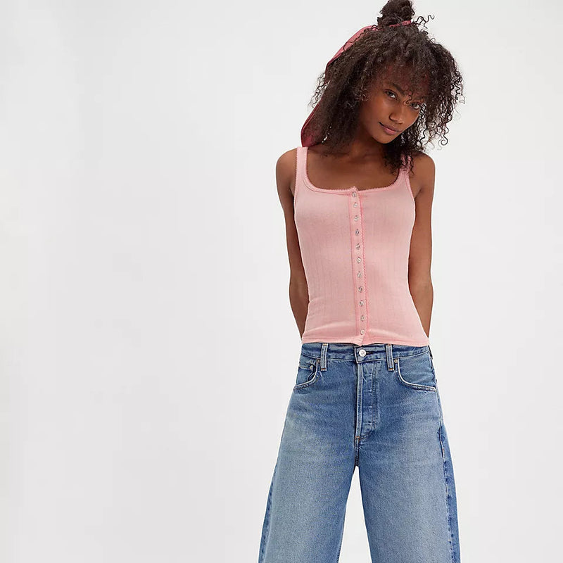 front view of the model wearing the end game pointelle tank. shows the pink color. also shows the button down style, the square neckline, the picot trim and the slim fit. 