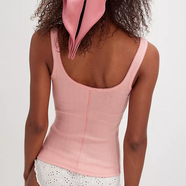 back view of the model wearing the end game pointelle tank. shows the scoop neckline. also shows the picot trim, the slim fit and light pink color. 
