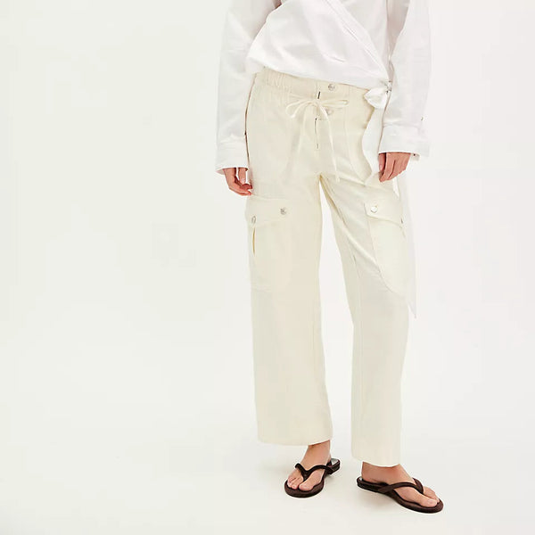 front view of the model wearing the park ave pant. shows the drawcord waist. also shows the multiple pockets, the high waist and the ivory color. 