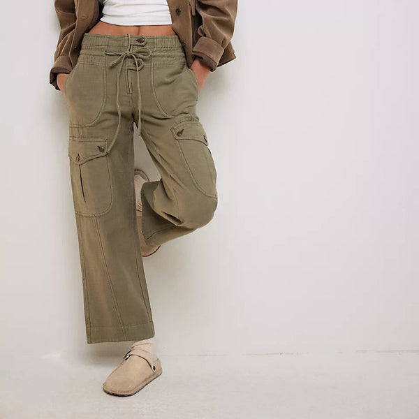 front view of the model wearing the drawcord waist. also shows the multiple pockets and the olive green color. 