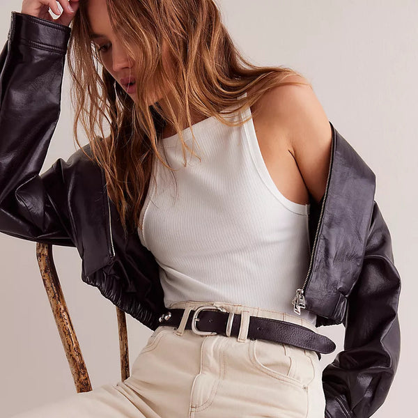 front view of the model wearing the mia tank. shows the high square neckline. also shows the dropped armholes, the ribbed detailing and ivory color. 