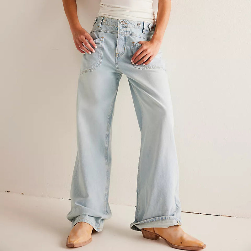 front view of the model wearing the palmer cuffed jean. shows the seamed pouch pockets. also shows the button/zip fly closure, the button detailing, the cuffed bottom and the loose fit. 