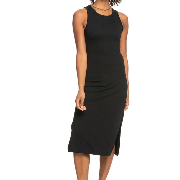FRONT VIEW OF THE MODEL WEARING THE GOOD KEEPSAKE MIDI DRESS IN BLACK. shows the scoop neckline. also shows the side slit and the more fitted fit. 