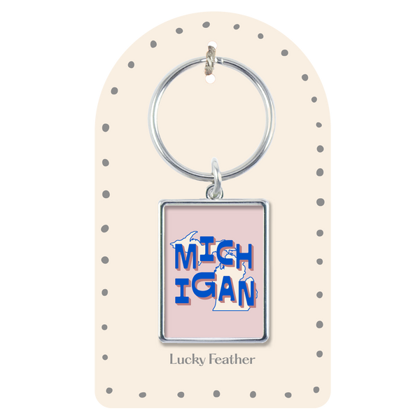 Keychain with 'Michigan' design on a polka dot card, brand 'Lucky Feather' visible