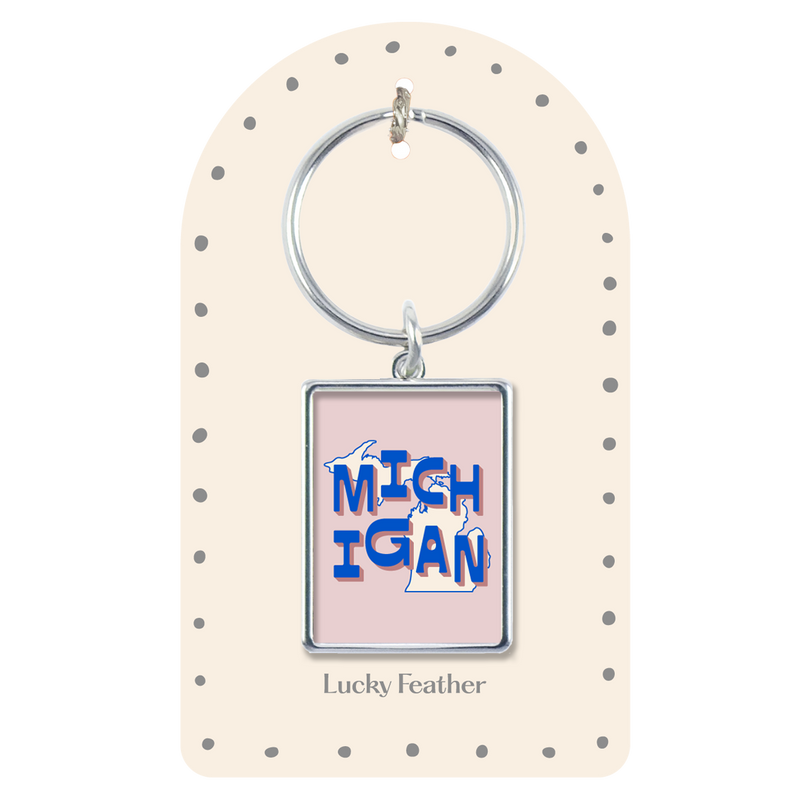 Keychain with 'Michigan' design on a polka dot card, brand 'Lucky Feather' visible