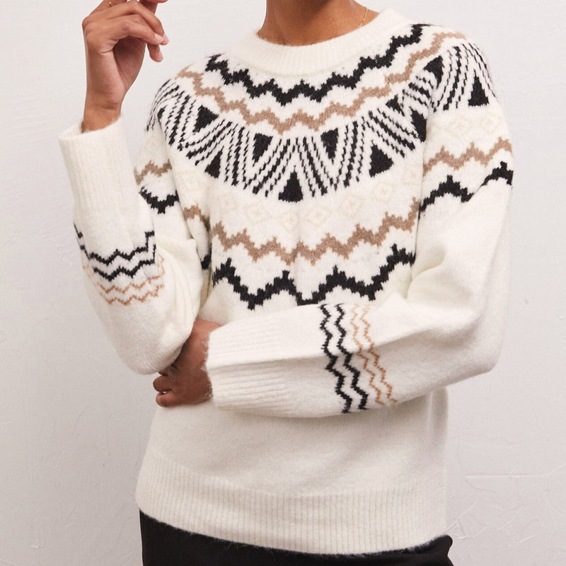 Front view of model wearing sweater. Shows the crew neckline. Also shows the ribbing detail on the neck, cuff and Botton hem, shows the fun fair isle print on upper sweater and sleeves. 