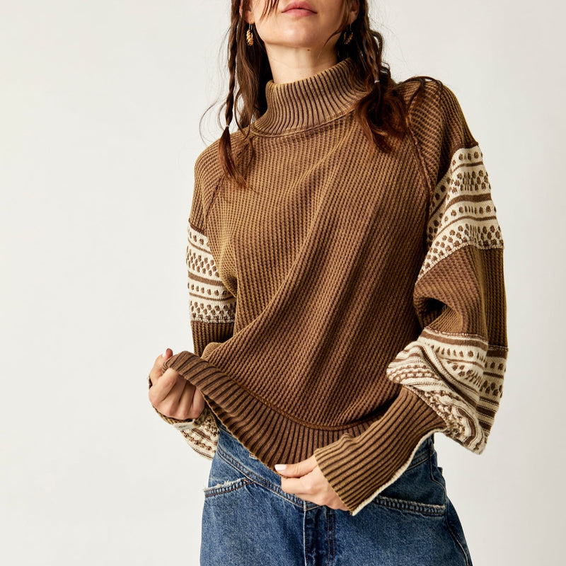 front view of model wearing the get cozy swit in hot fudge. shows the mock neckline. also shows the ribbed bottom hem and cuffs, the cream detailing throughout, the slouchy, relaxed fit and the tight cuffs.