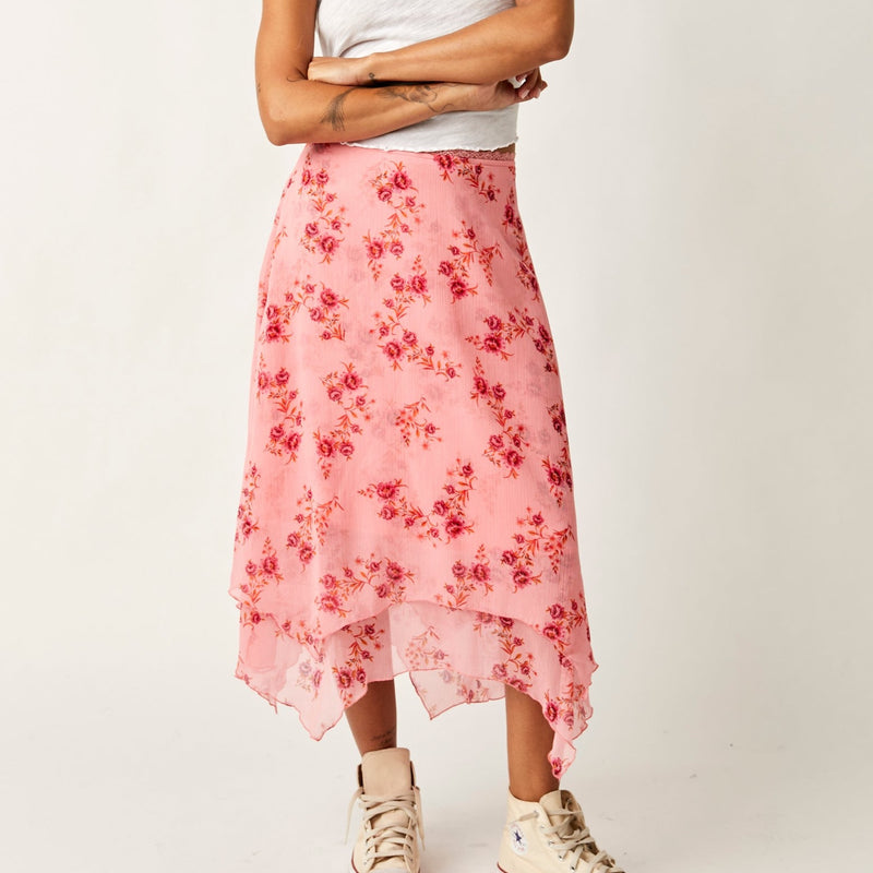 front view of the garden party skirt in pink blossom. shows the scalloped waistband. also shows the vintage floral print and the asymmetrical bottom hem. 