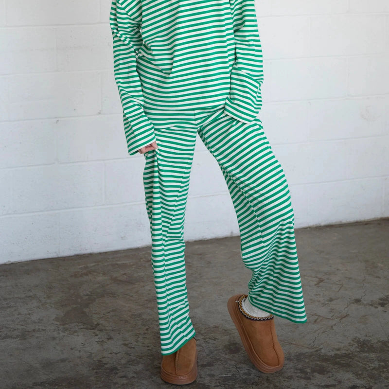 front view of the model wearing the frankie pants. shows the green and white stripes. also shows the wide legs, and the pull on style. 