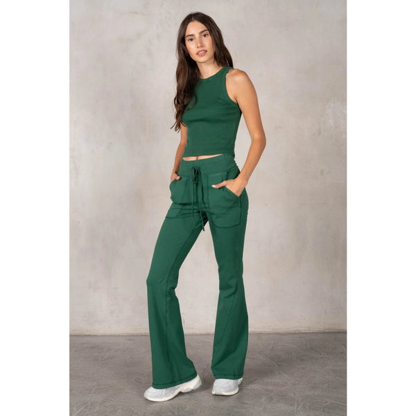 Woman wearing a green outfit against a plain background