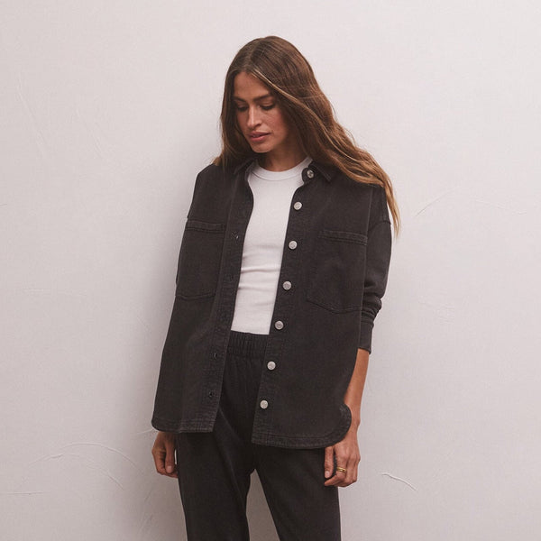 front view of model in jacket. shows the loose fit, front pouch pockets and buttons down the front.