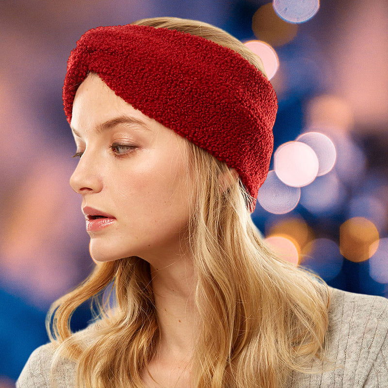 front view of model wearing earmuff headband. Shows the front tie knot detail and the sherpa fleece material in this burgundy color.  