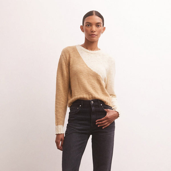front view of model in sweater. showcases the crew neckline, long sleeves with dropped shoulders, and colorblock feature.
