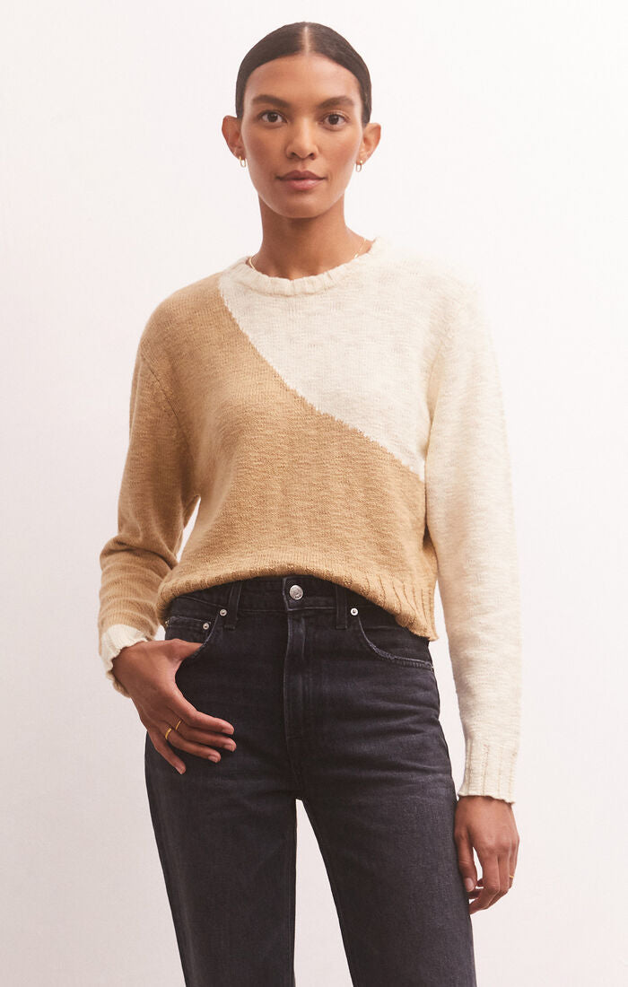 another front view of model in sweater. showcases the crew neckline, long sleeves with dropped shoulders, and colorblock feature.