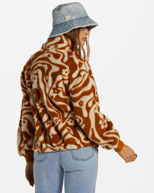 back view of model in zip up. shows the fleece fabric, dropped shoulders, and fitted elastic cuffs.